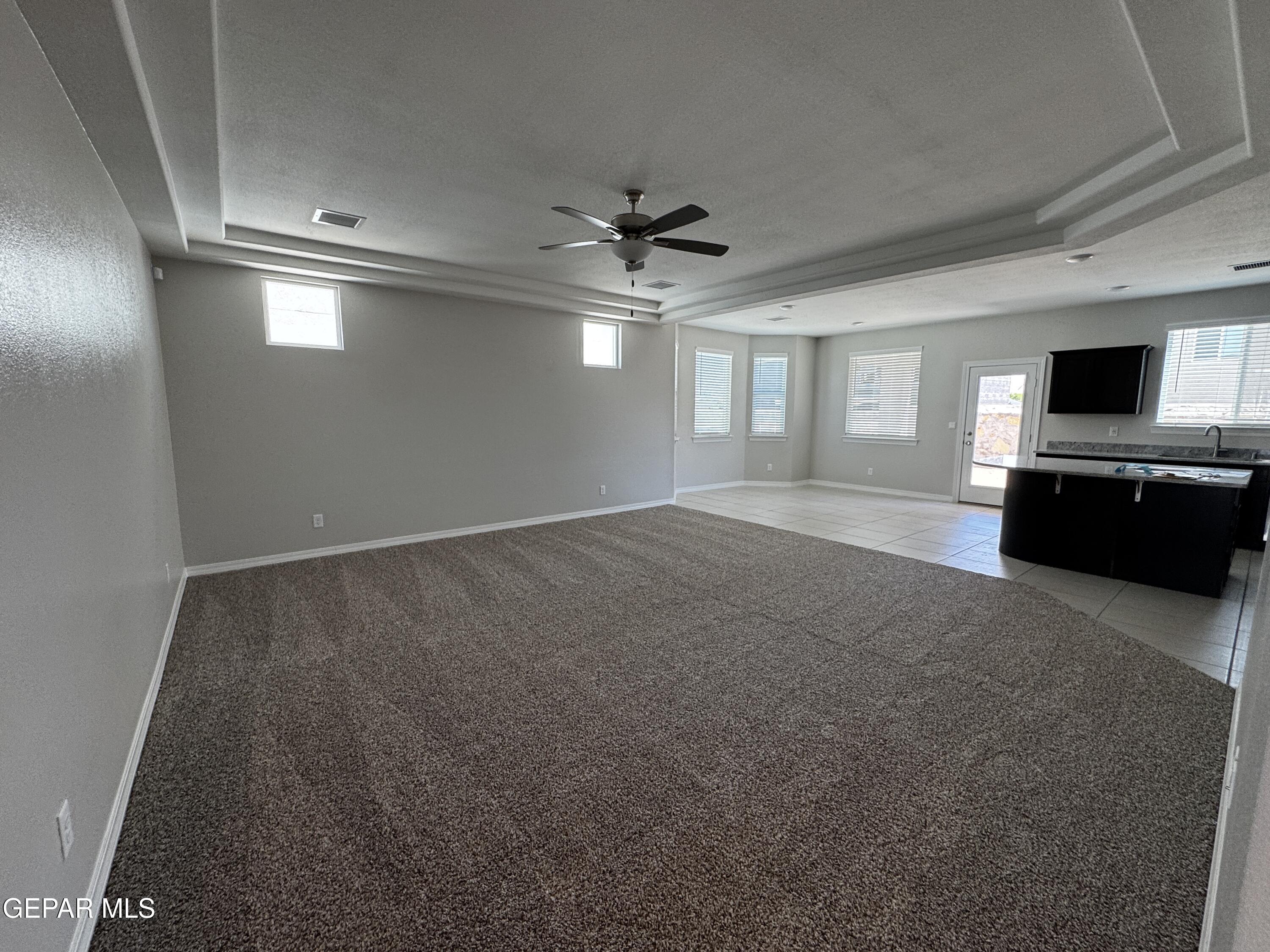 14434 Aria Lopez Drive El Paso, TX 79938 - Photo 18 of 37 an empty room with windows and ceiling fan