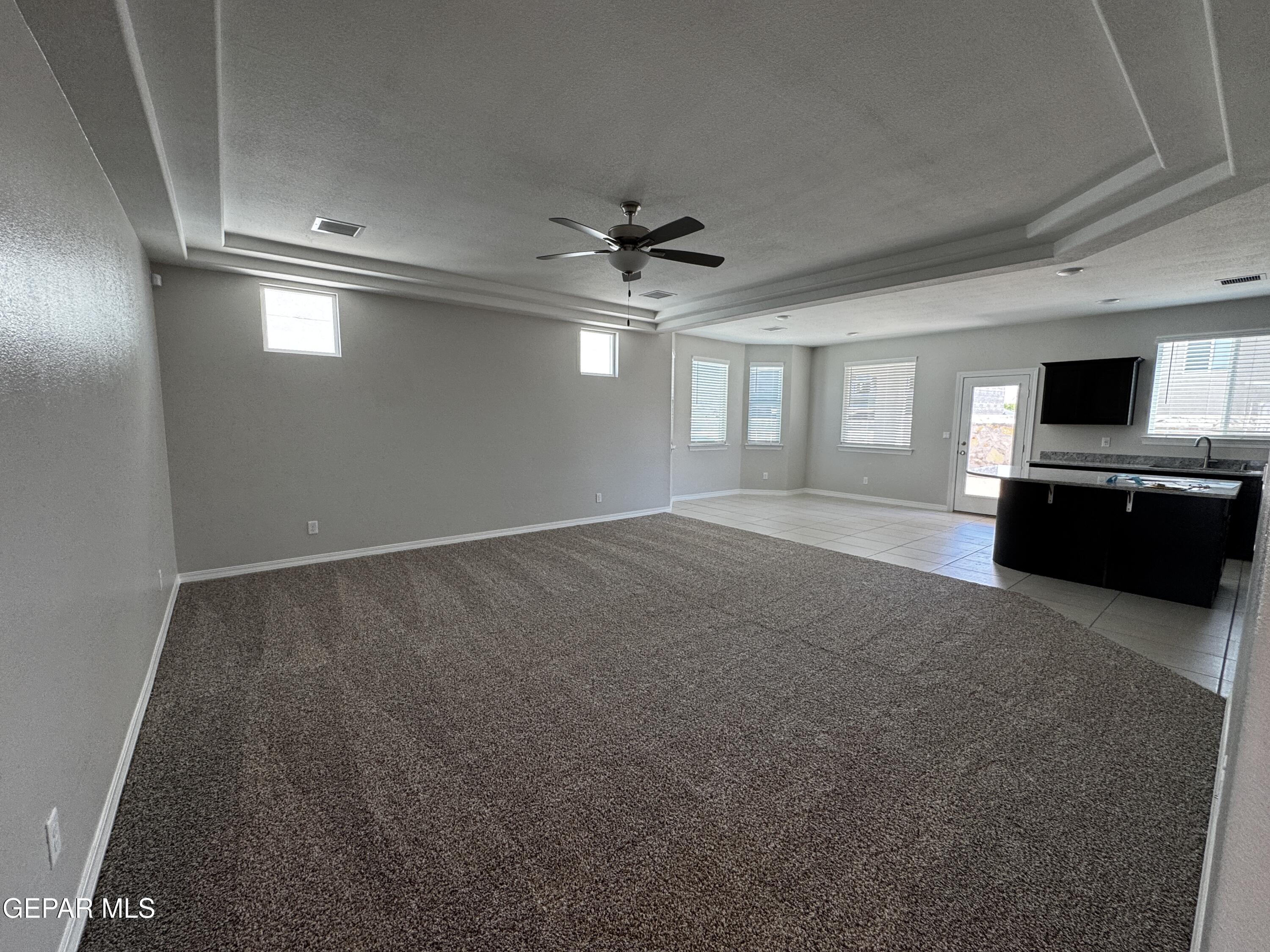 14434 Aria Lopez Drive El Paso, TX 79938 - Photo 19 of 37 an empty room with windows and ceiling fan