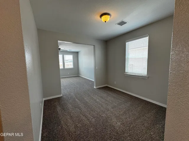 an empty room with windows and closet