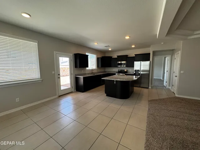 a kitchen with stainless steel appliances granite countertop a sink and cabinets