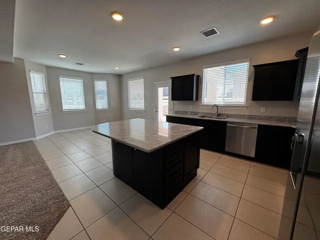a kitchen with a sink window and cabinets