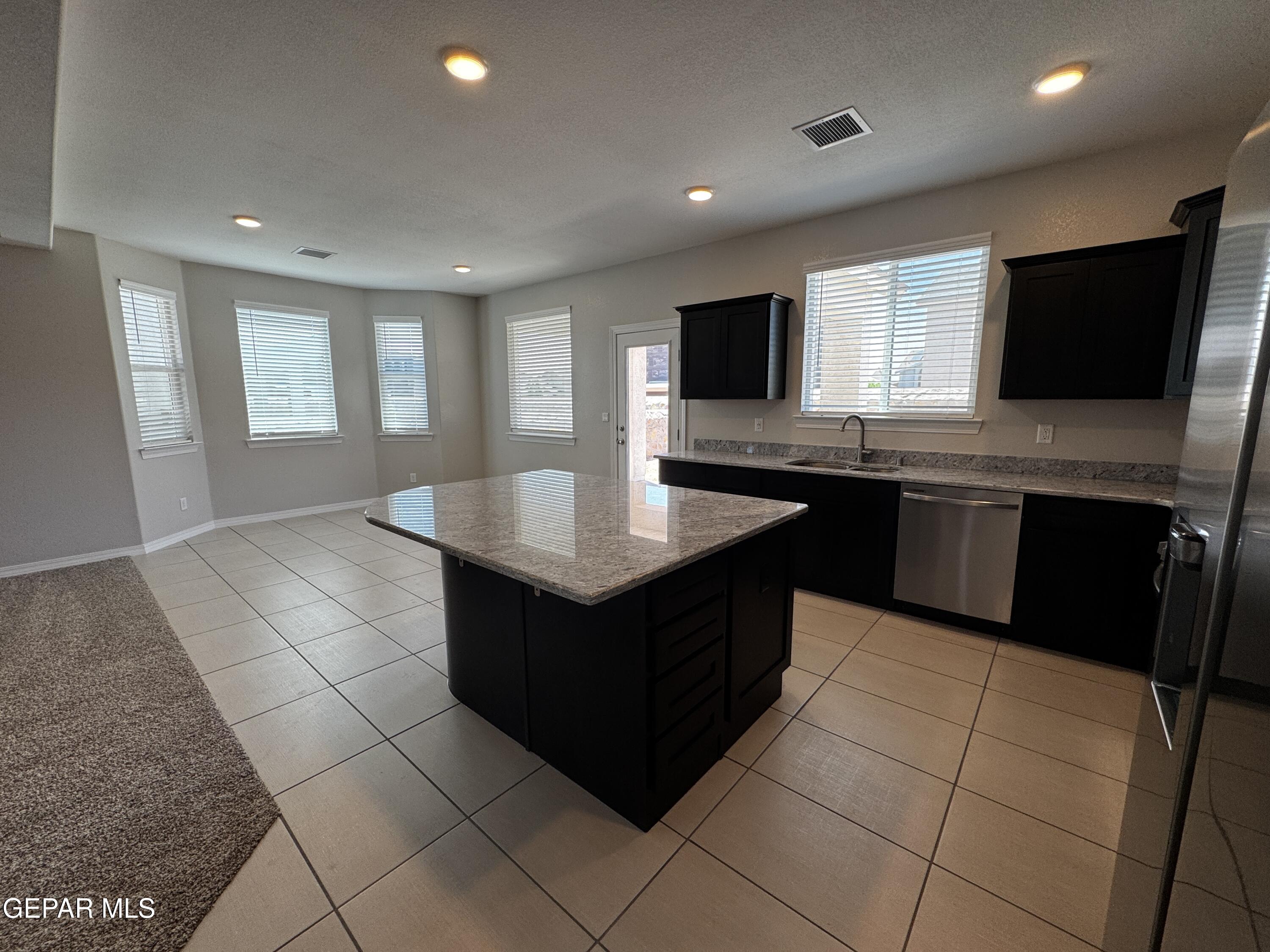 14434 Aria Lopez Drive El Paso, TX 79938 - Photo 8 of 37 a kitchen with a sink window and cabinets