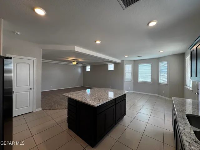 a kitchen with kitchen island cabinets and window