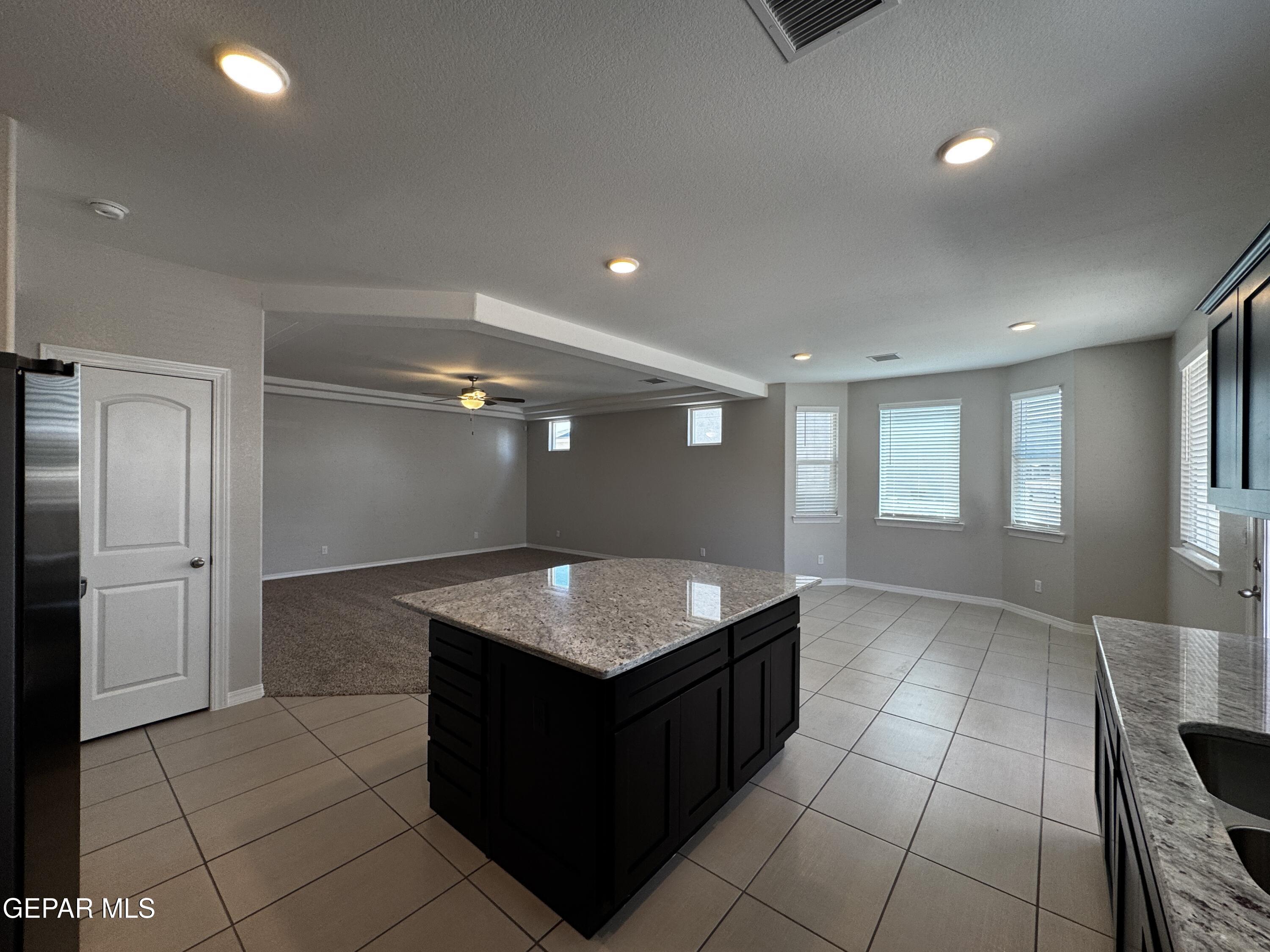 14434 Aria Lopez Drive El Paso, TX 79938 - Photo 9 of 37 a kitchen with kitchen island cabinets and window