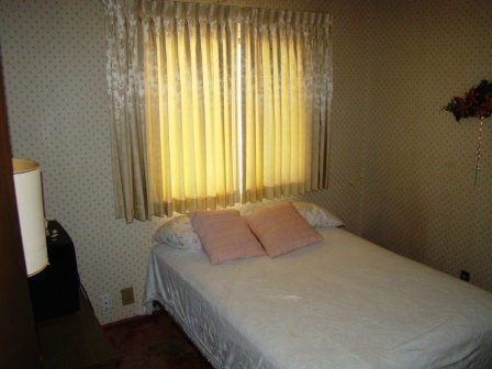 12221 Sandstone Drive Redding, CA 96003 - Photo 26 of 33 a bedroom with a bed and a window