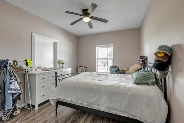 a bedroom with a bed and a chandelier