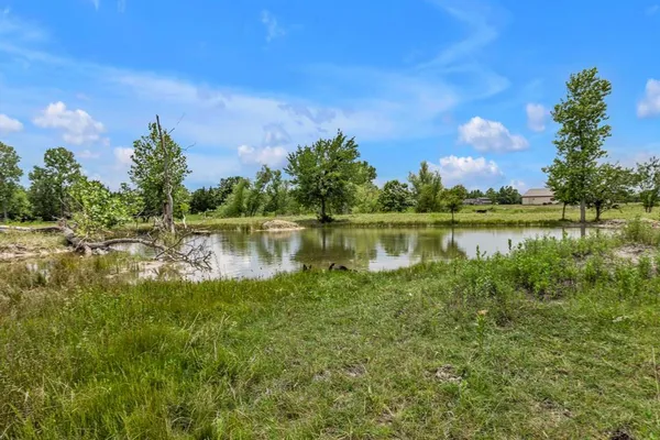 a view of a lake with houses in the back