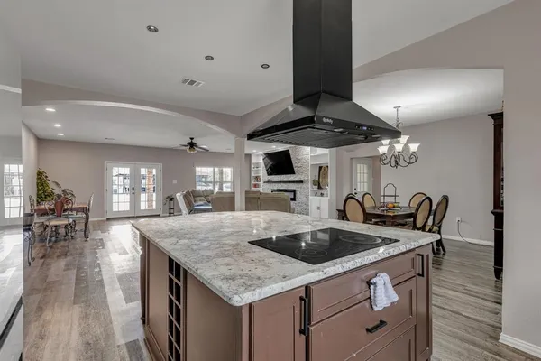 a kitchen with stainless steel appliances granite countertop a sink a stove and a refrigerator
