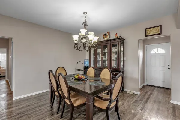 a dining room with furniture and wooden floor