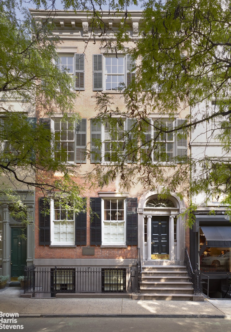 a front view of a residential apartment building with a yard