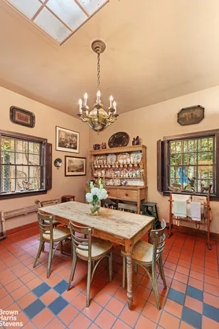 a view of a dining room with furniture and chandelier