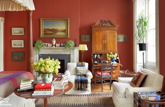 a living room with furniture a fireplace and a potted plant