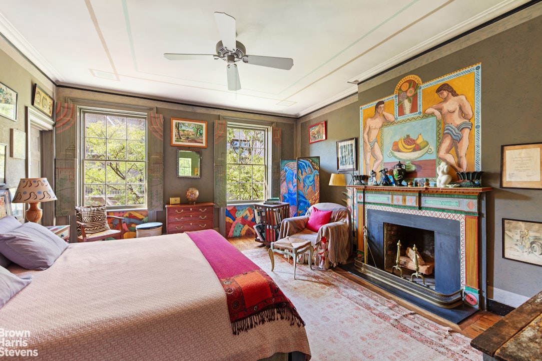 203 Prince Street Manhattan, NY 10012 - Photo 18 of 45 a bed room with a bed furniture and a fireplace