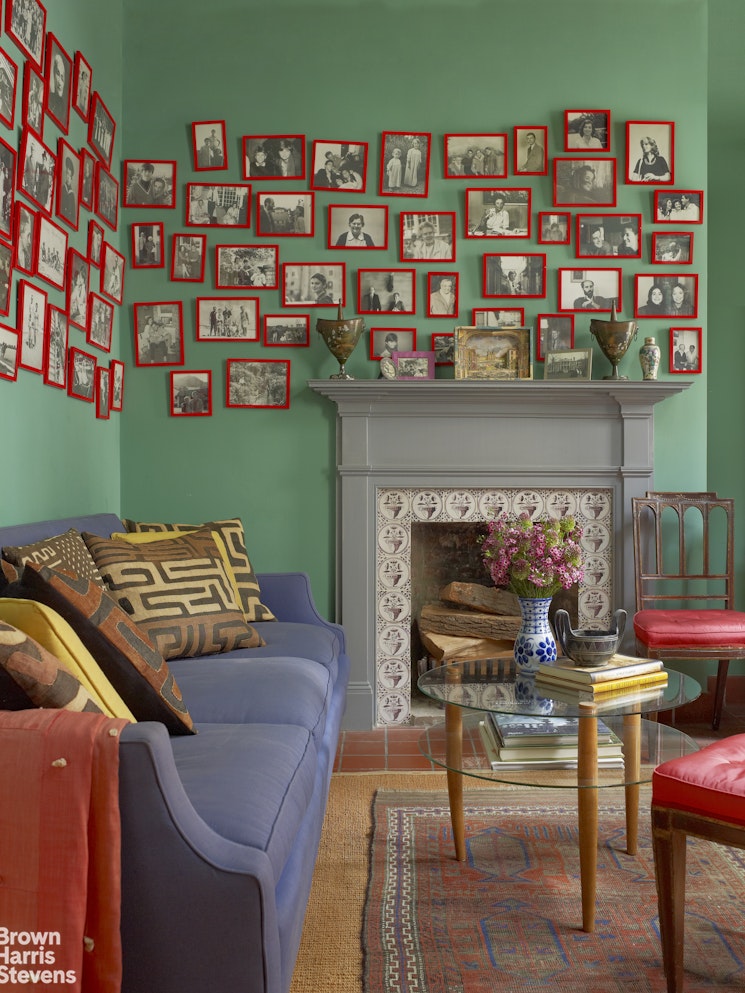203 Prince Street Manhattan, NY 10012 - Photo 19 of 45 a living room with furniture a bookshelf and a fireplace