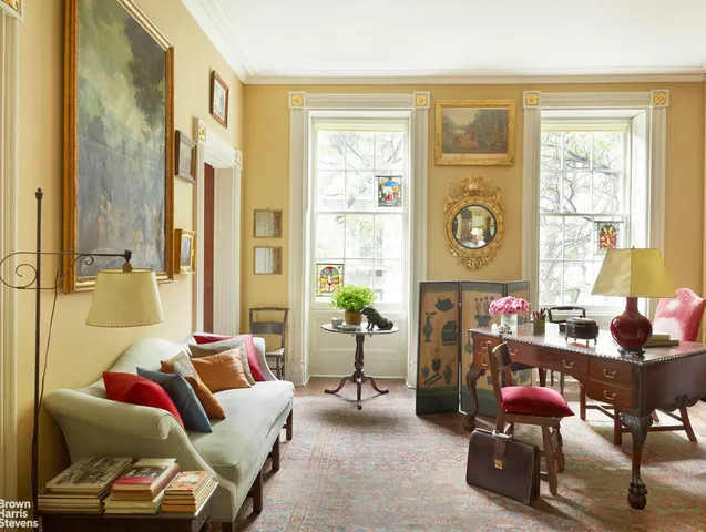 a living room with furniture a bookshelf and a fireplace