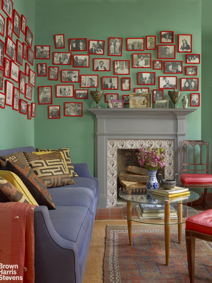 203 Prince Street Manhattan, NY 10012 - Photo 40 of 45 a living room with furniture a bookshelf and a fireplace