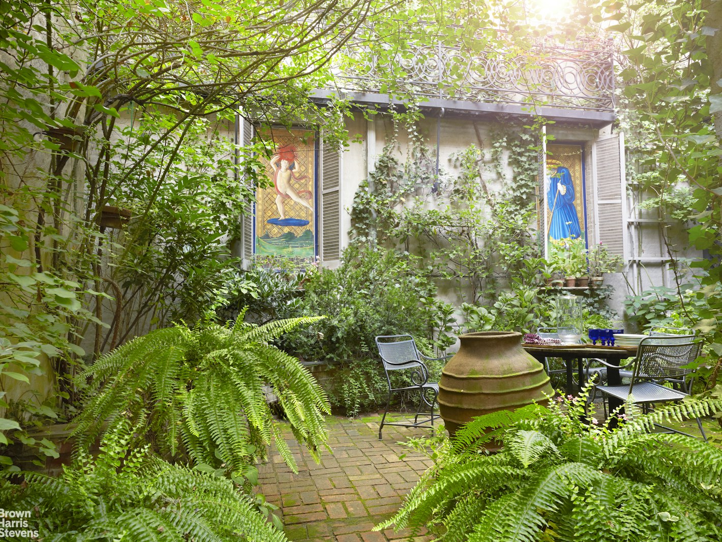 203 Prince Street Manhattan, NY 10012 - Photo 42 of 45 a backyard of a house with outdoor seating and plants