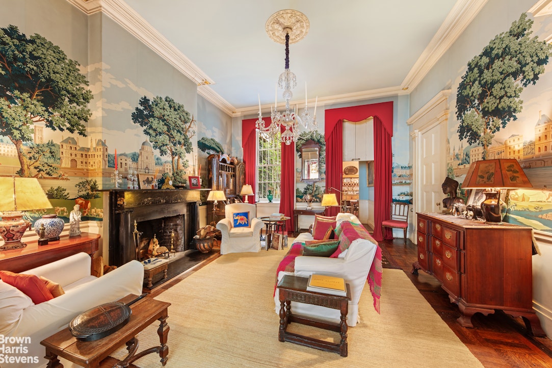 203 Prince Street Manhattan, NY 10012 - Photo 6 of 45 a living room with furniture a fireplace and a chandelier