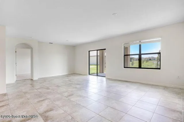 a view of an empty room with windows