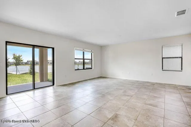 a view of an empty room with windows