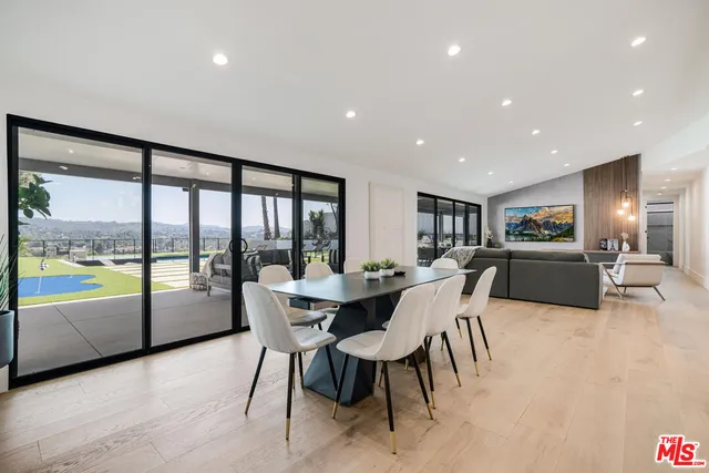 a large kitchen with a table and chairs
