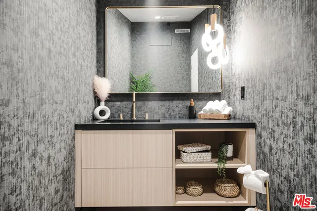 a bathroom with a sink and a mirror