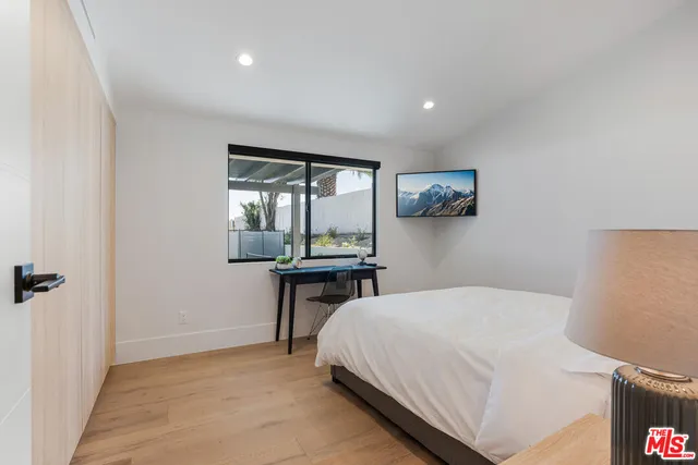 a bedroom with a bed and a table