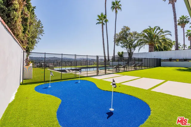 a view of a swimming pool with a seating space