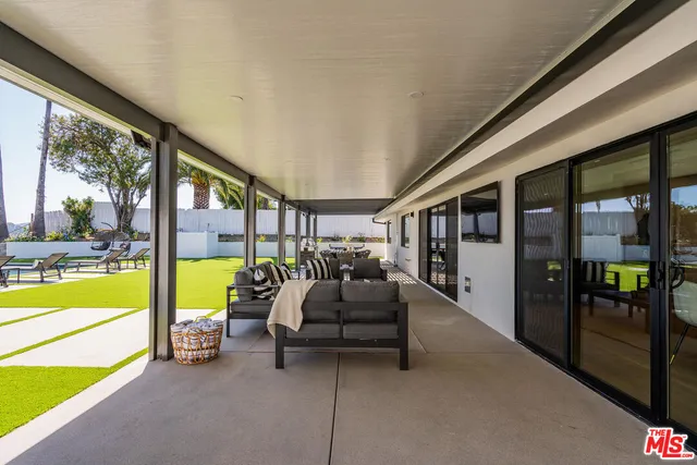 a living room with couch and a floor to ceiling window