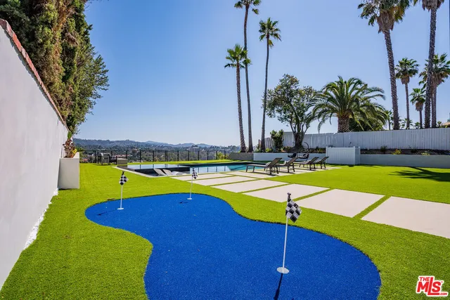 a view of a backyard with swimming pool