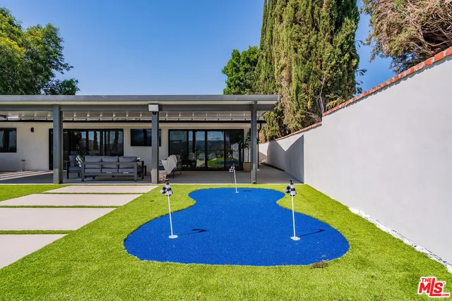 a view of outdoor kitchen and swimming pool