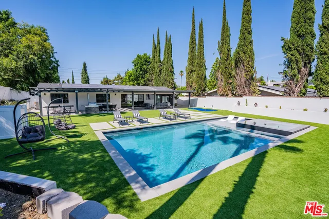 a view of a swimming pool with chairs