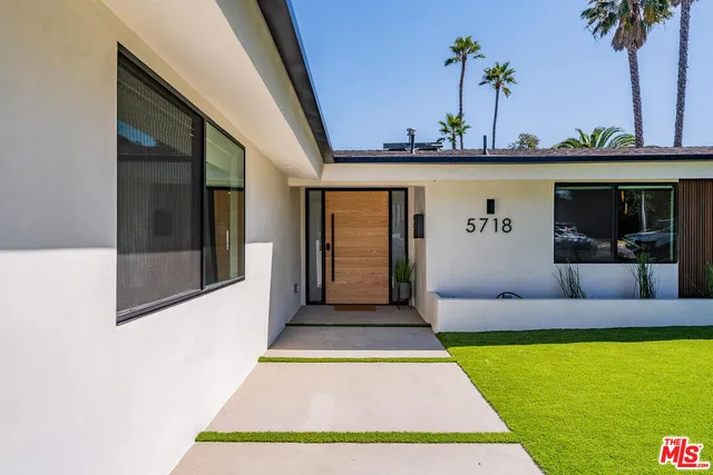 a view of an entryway with a table and chair