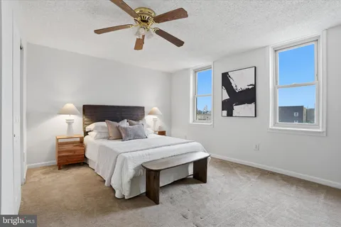 a bedroom with a bed rug and window