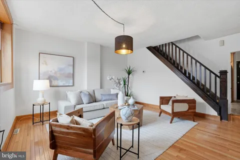 a living room with furniture and wooden floor