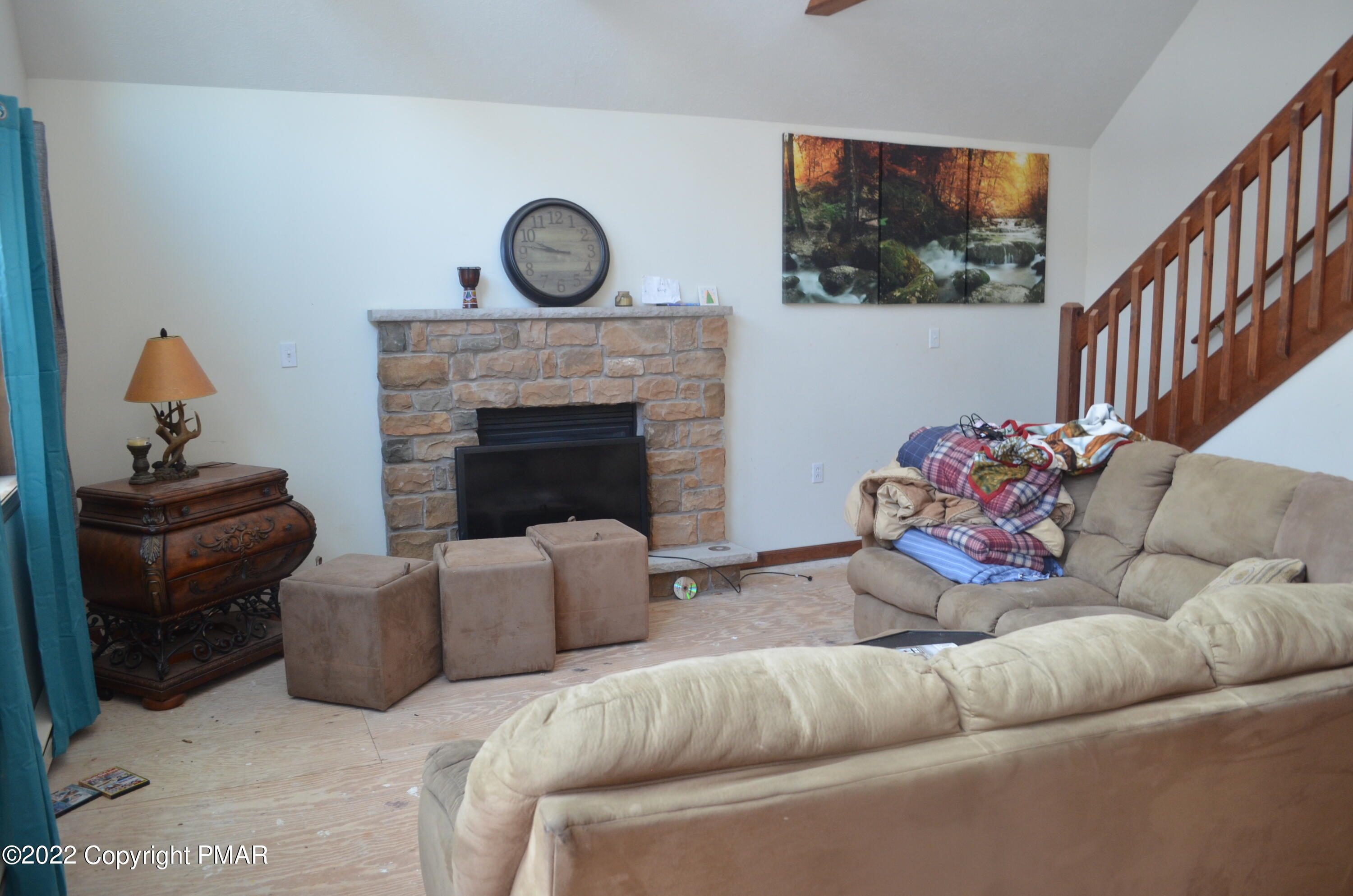 145 Pontiac Path Pocono Lake, PA 18347 - Photo 2 of 13 a living room with furniture a fireplace and a flat screen tv