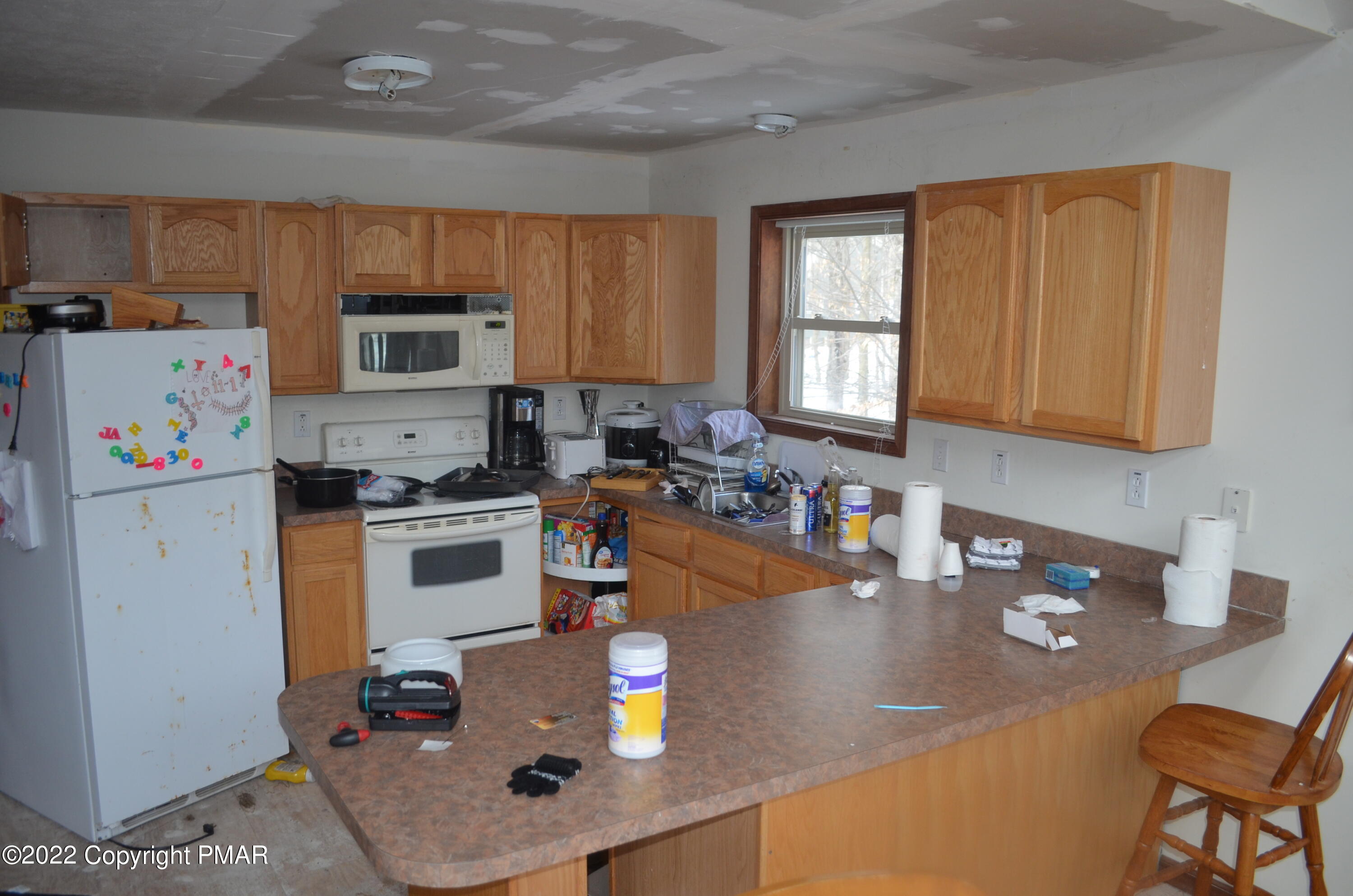 145 Pontiac Path Pocono Lake, PA 18347 - Photo 4 of 13 a kitchen with stainless steel appliances granite countertop a refrigerator sink stove microwave and cabinets