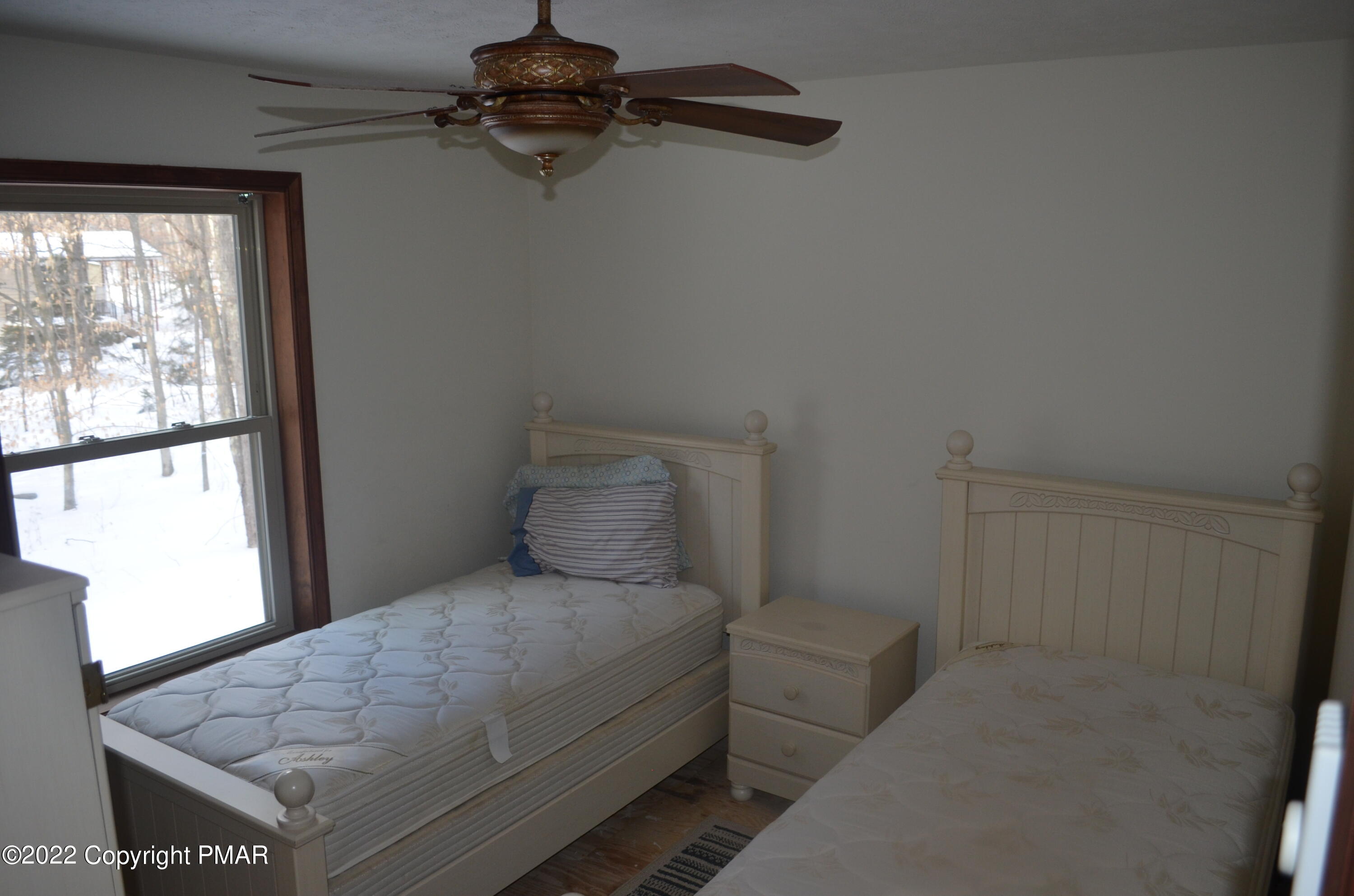 145 Pontiac Path Pocono Lake, PA 18347 - Photo 7 of 13 a bedroom with a bed and a window