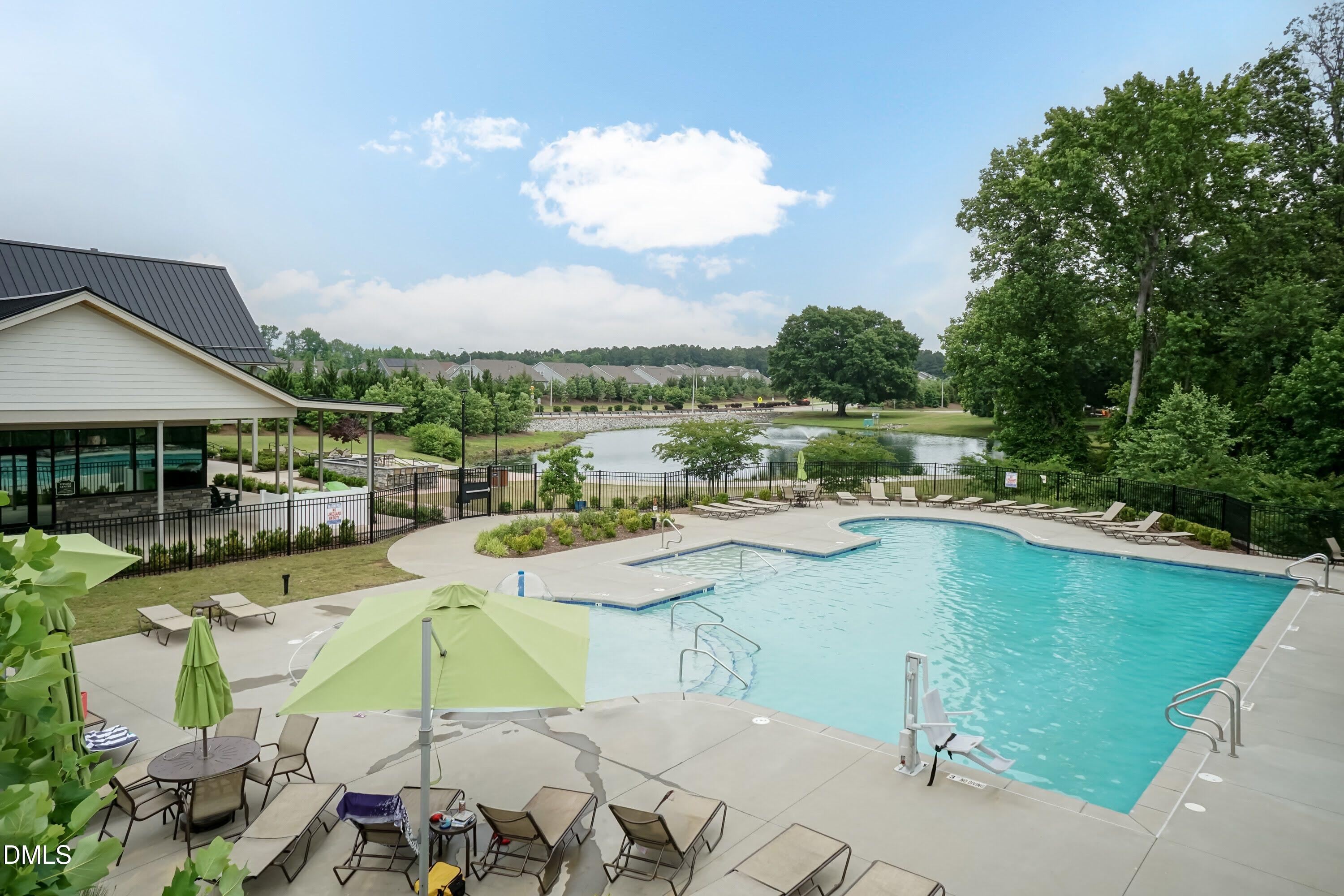503 Ressler Street Holly Springs, NC 27540 - Photo 46 of 47 a view of a lake with a table and chairs