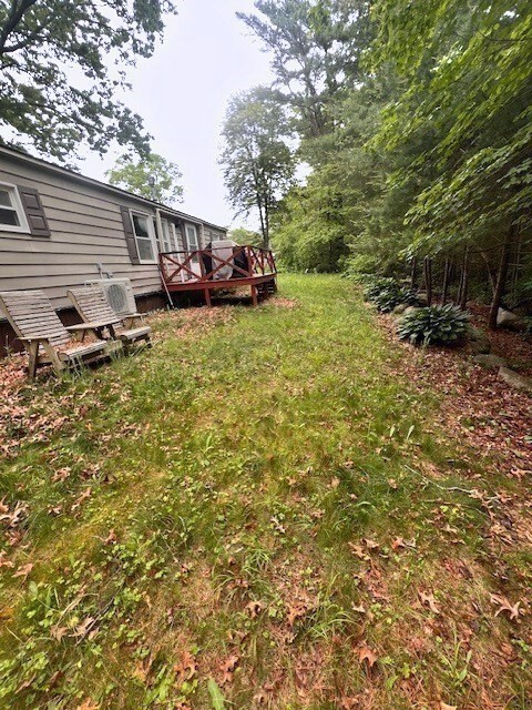 217 Cheshire Park Wareham, MA 02571 - Photo 11 of 13 a view of a small yard with plants and large tree