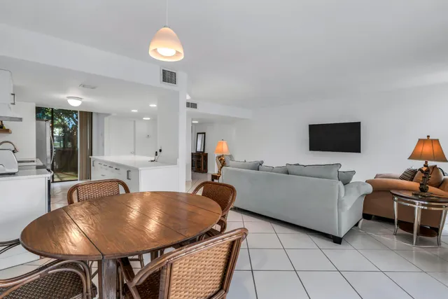 a kitchen with refrigerator and chairs