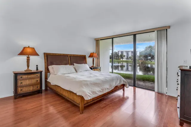 a bathroom with a toilet a sink a mirror and vanity