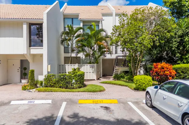 a view of a house with swimming pool and sitting area