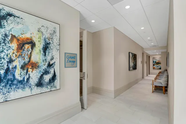 a view of swimming pool with palm trees in front of house