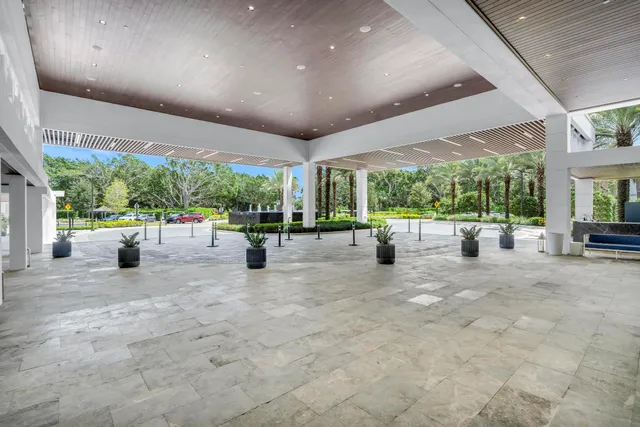 an aerial view of a residential houses with outdoor space and trees all around