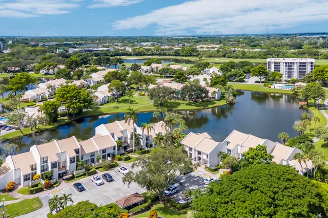 an aerial view of a residential houses with outdoor space and street view