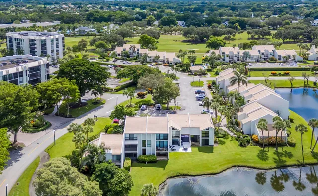 an aerial view of a house with a swimming pool and outdoor seating