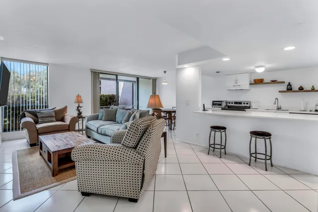 a view of a dining room with furniture and chandelier