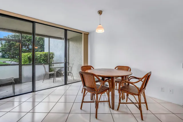 a kitchen with a refrigerator a sink and a stove top oven with wooden floor