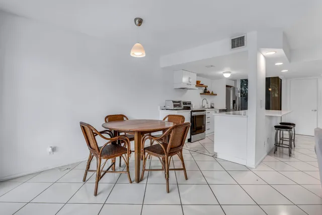 a kitchen with stainless steel appliances a sink and a refrigerator